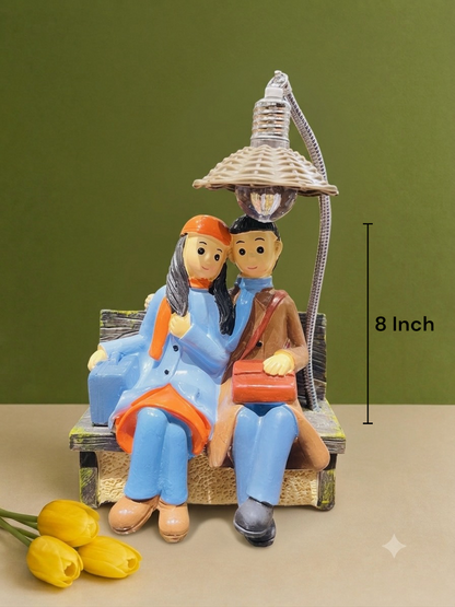 Cozy Traveler Couple Sitting on Bench Resin Statue 8 Inch Lighted Showpiece